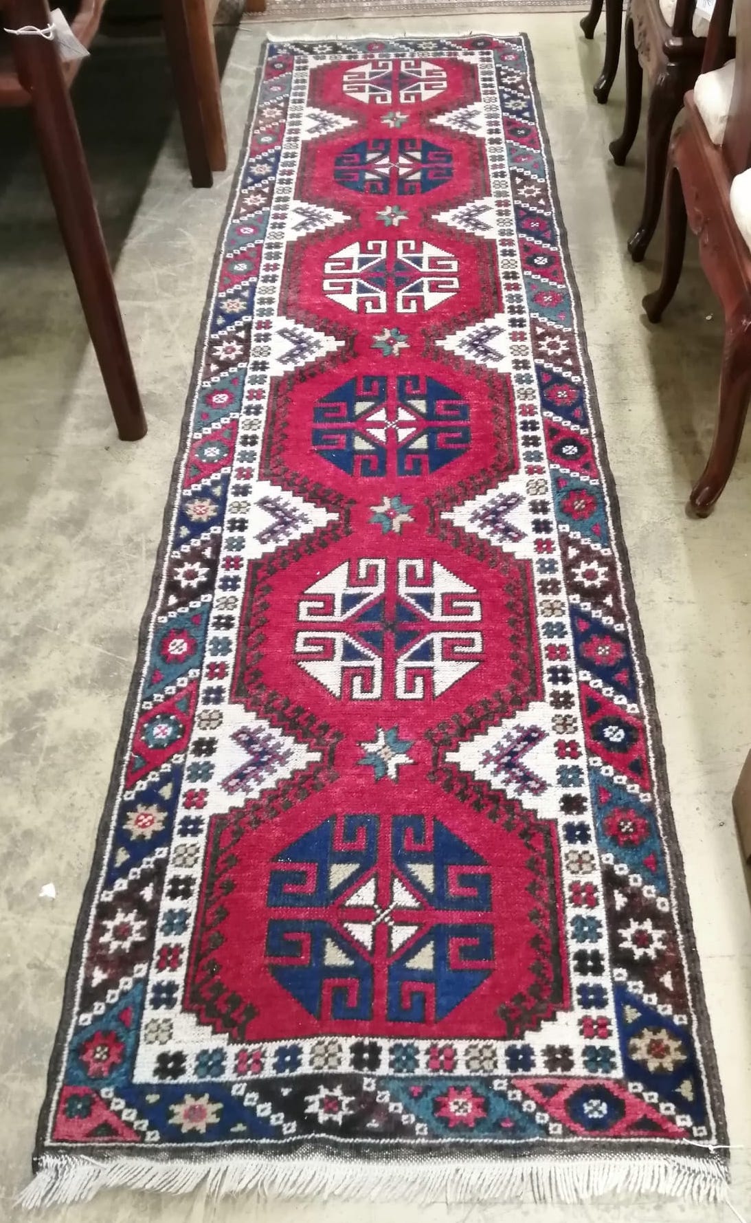 A Caucasian style red ground runner, 274 x 72cm